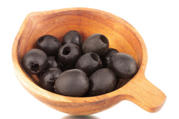 A few pickled black olives in a wooden cup, macro, isolated on white.