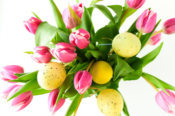 spring flat lay with tulips and easter eggs on white