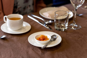 Juicy ripe cloudberry northern in a plate. Many plates on the table.