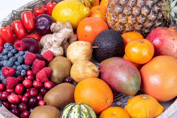 fresh vegetables and fruits isolated on a white background in wooden tray.