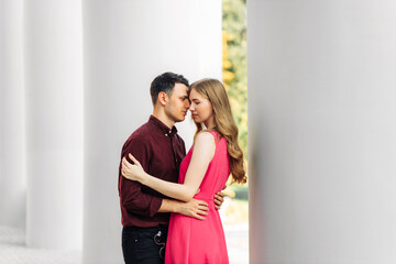 Fototapeta premium Happy beautiful couple in love looking at each other, attractive man hugging woman