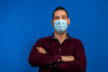 Portrait of confident positive guy cross hands ready stop covid-19 infection spread wear violet clothing medical mask isolated over bright blue shine color background
