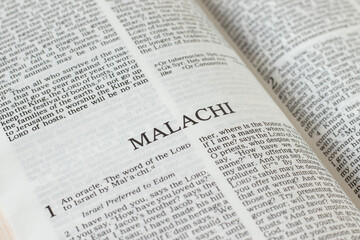 Malachi open Holy Bible Book close-up. Old Testament Scripture prophecy. Studying the Word of God Jesus Christ. Christian biblical concept of faith, hope, and trust.