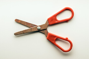 Old rusty scissors with plastic handles