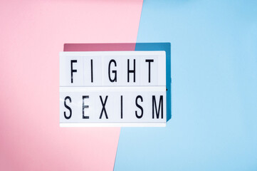 Fight sexism text on the lightbox. Feminism concept. Top view.