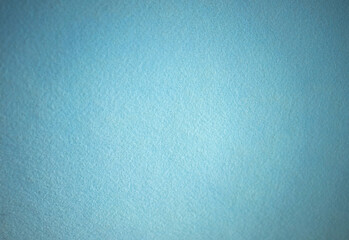 Photo of a blue texture made of soft felt fabric. Clean sea breeze background for text.