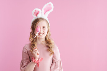 Portrait of smiling modern girl in pink dress on pink