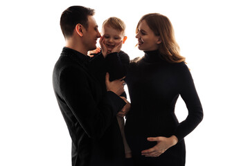 pregnant woman, her husband and little son are talking and smiling while spending time together