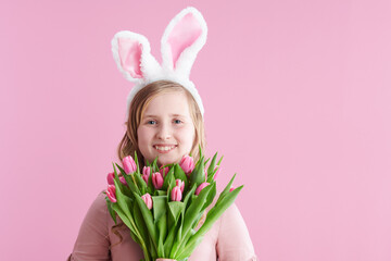 Portrait of happy modern child with long wavy blond hair on pink