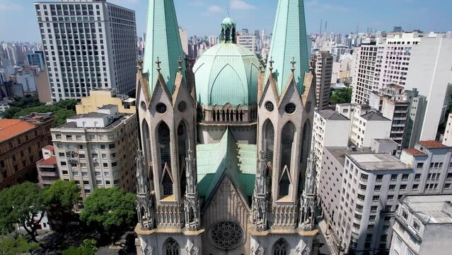 Panning wide of famous catholic church Metropolitan Cathedral of Sao Paulo at ground zero of downtown Sao Paulo Brazil located at S&eacute; Square. Historic medieval building. Religion scenery.