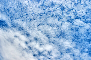 Fototapeta na wymiar Volumetric blue sky with textured white clouds