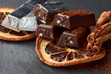 Dark chocolate with crushed almonds, cocoa powder, dried orange slices