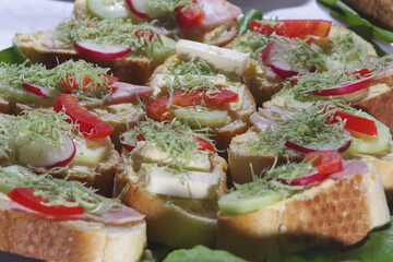 Club sandwich with sausage on a white plate. Club sandwich with cheese and green salad food traditional homemade