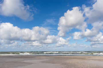 Sky with clouds over a narrow strip of sea coast on the Baltic Sea..