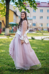 Beautiful schoolgirl in dress at the prom at school.