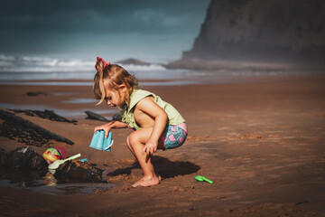 child playing on the beach in portugal algarve