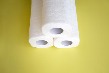 Absorbent paper napkin kitchen towels on yellow background.