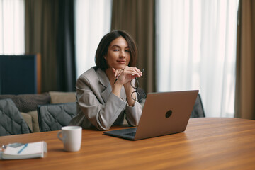 Portrait of beautiful successful businesswoman sit at laptop at office looking at camera. Professional lawyer consultant
