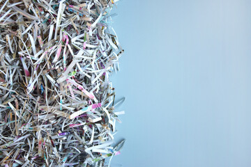 The shredded paper on light blue background.