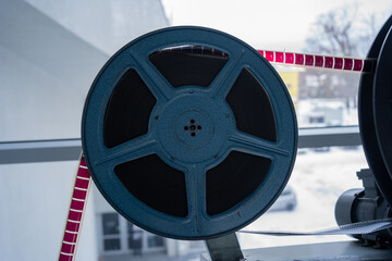 old metal cinema film spool with coloured film strip