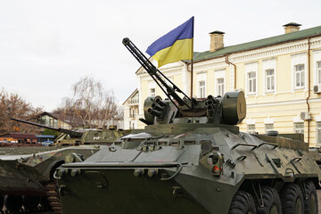 Fototapeta na wymiar Army troops transporter and tank with Ukrainian flag, Ukraine - Russia war crisis concept, Kyiv