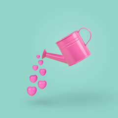 Obraz premium Watering can pouring pastel pink hearts isolated on a turquoise background. Valentines Day concept.