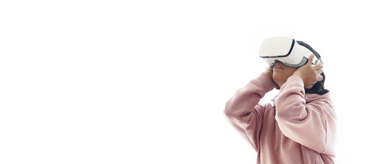 The girl is having fun in virtual reality glasses. A woman in pink clothes stands on a white isolated background. High quality photo