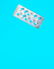 blisters with blue pills on a blue background