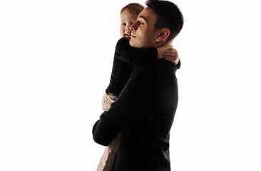 Happy father holding adorable little son and smiling over white background. Smiling father plays with his little son