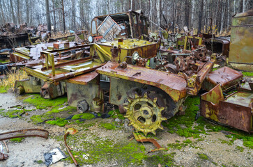 Fototapeta na wymiar A bunch of old rotten Soviet rusty automobile abandoned in the woods. Car dump