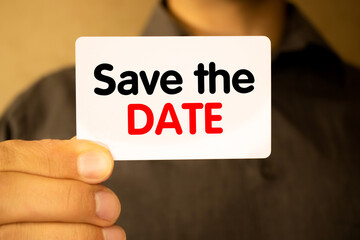 Business and people concept. On a gray background, a business card with the inscription - Save the date