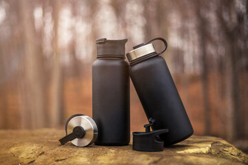 Black water bottle thermos in nature