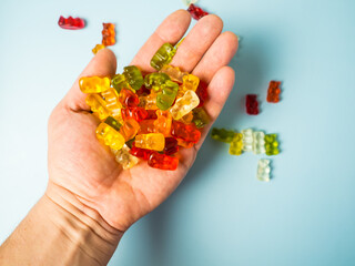 Close-up of a man holding colorful gummy bears