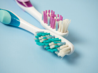 old toothbrushes on a blue background .used male and female toothbrushes