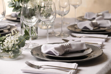 Stylish elegant table setting for festive dinner in restaurant