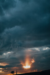 Fototapeta na wymiar beam of light between clouds at cloudy sunset