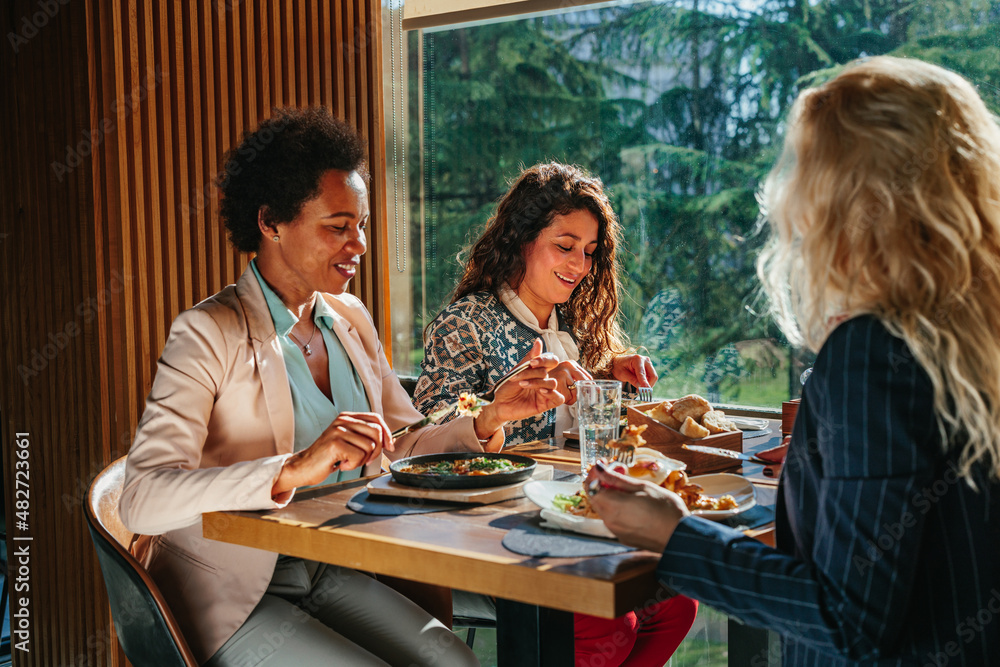 Wall mural three business women having lunch break