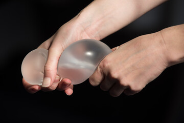 Silicone implant of the female breast during the demonstration of its quality.