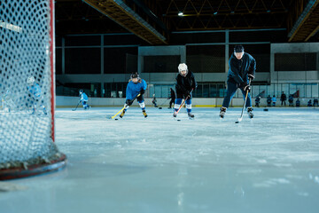 Ice hockey practice session on indoor rink - Powered by Adobe
