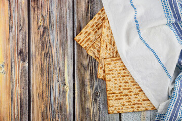 Jewish matzah bread with tallit on wooden background. Passover holiday concept