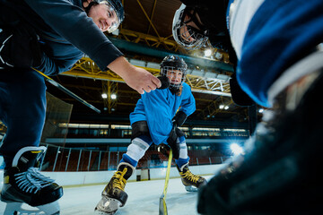 Ice hockey referee holding pack at match