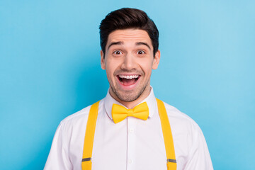 Photo of attractive impressed guy dressed white shirt yellow bowtie open mouth isolated blue color background
