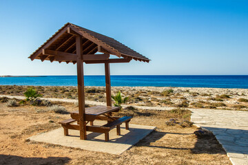 beautiful bench near the sea shore on nature background