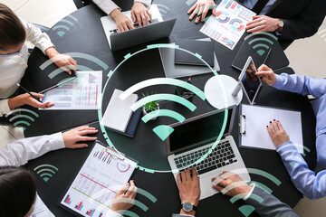 Business people with modern devices using wi-fi in office, top view - obrazy, fototapety, plakaty