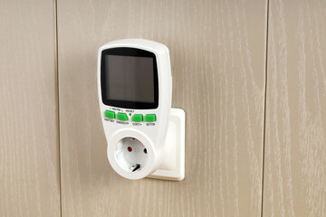 Wattmeter for measuring electricity costs in devices connected to outlet, saving, expense analysis, in socket on wall