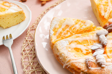 Plate with tasty citrus cake with oranges on table