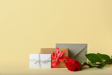 Valentine's Day gift, envelopes and rose on color background