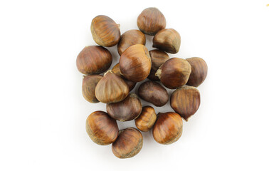 Pile of brown dry chestnuts isolated on white background