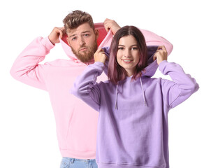 Cool young couple in hoodies on white background
