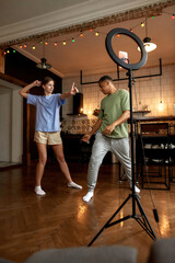 Obraz na płótnie Canvas Dancing blogger couple making video at home